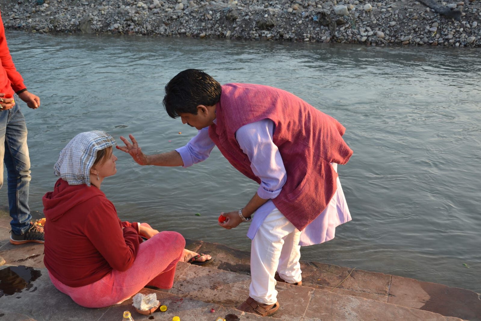 Acharya Rajeev performing a blessing beside the Ganga for a retreat guest